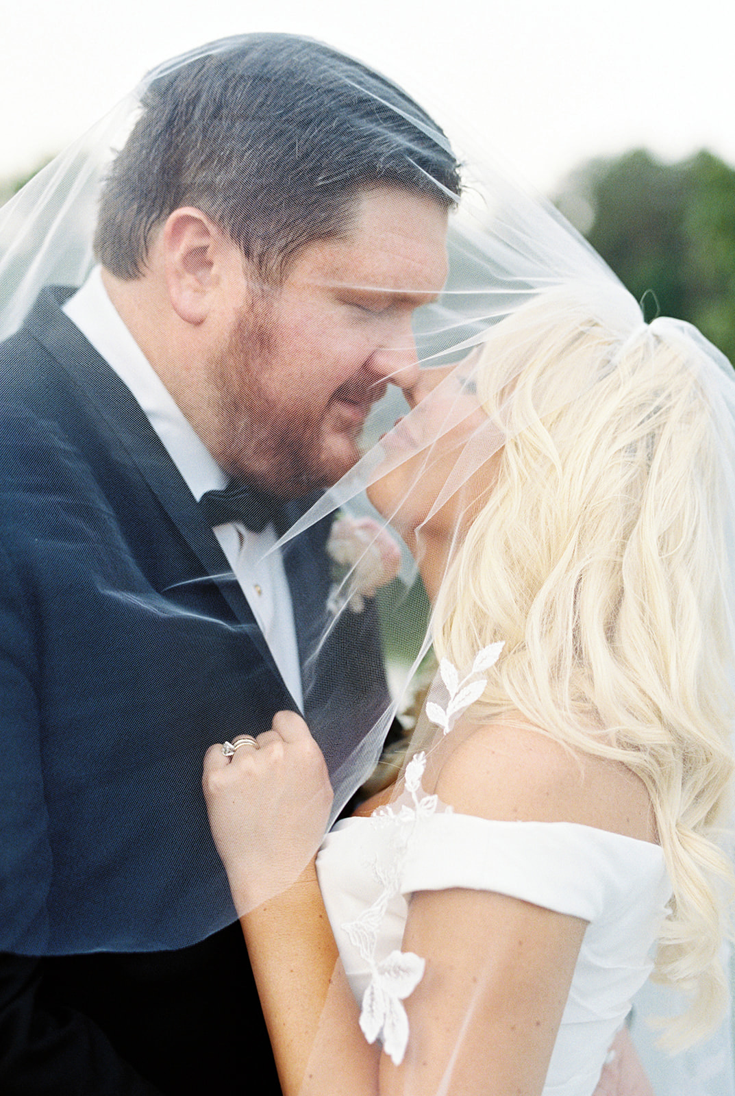 An intimate moment between bride and groom under the veil in Huntsville, Alabama