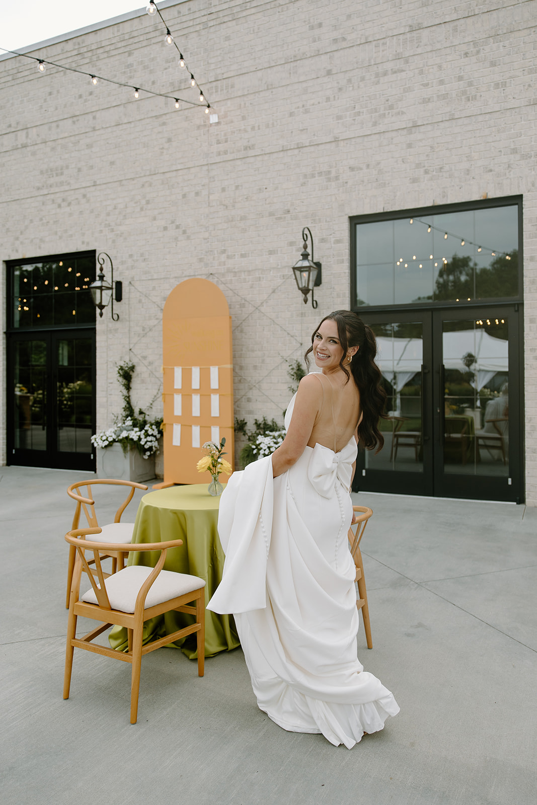 Bride at summer wedding cocktail hour captured by Raleigh wedding photographers