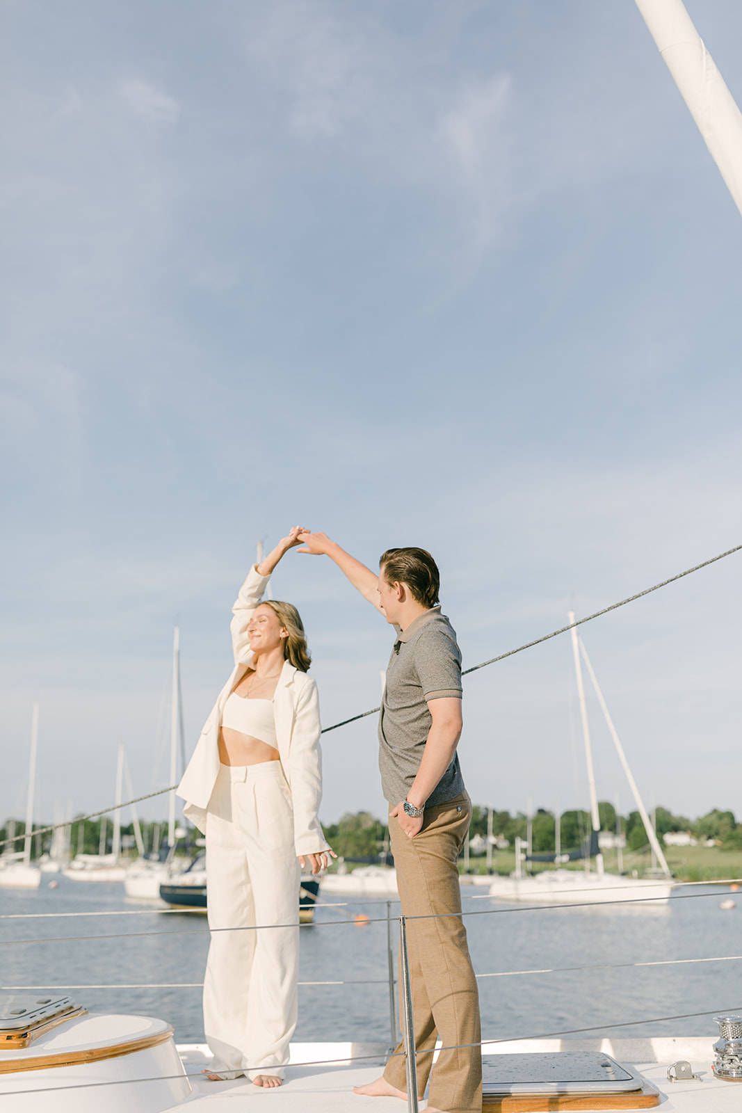 couple on sailboat for engagement photos in connecticut