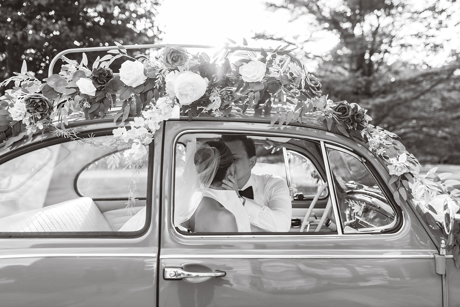 Married couple outside of church for couple's portraits with vintage VW decorated with "just married" sign