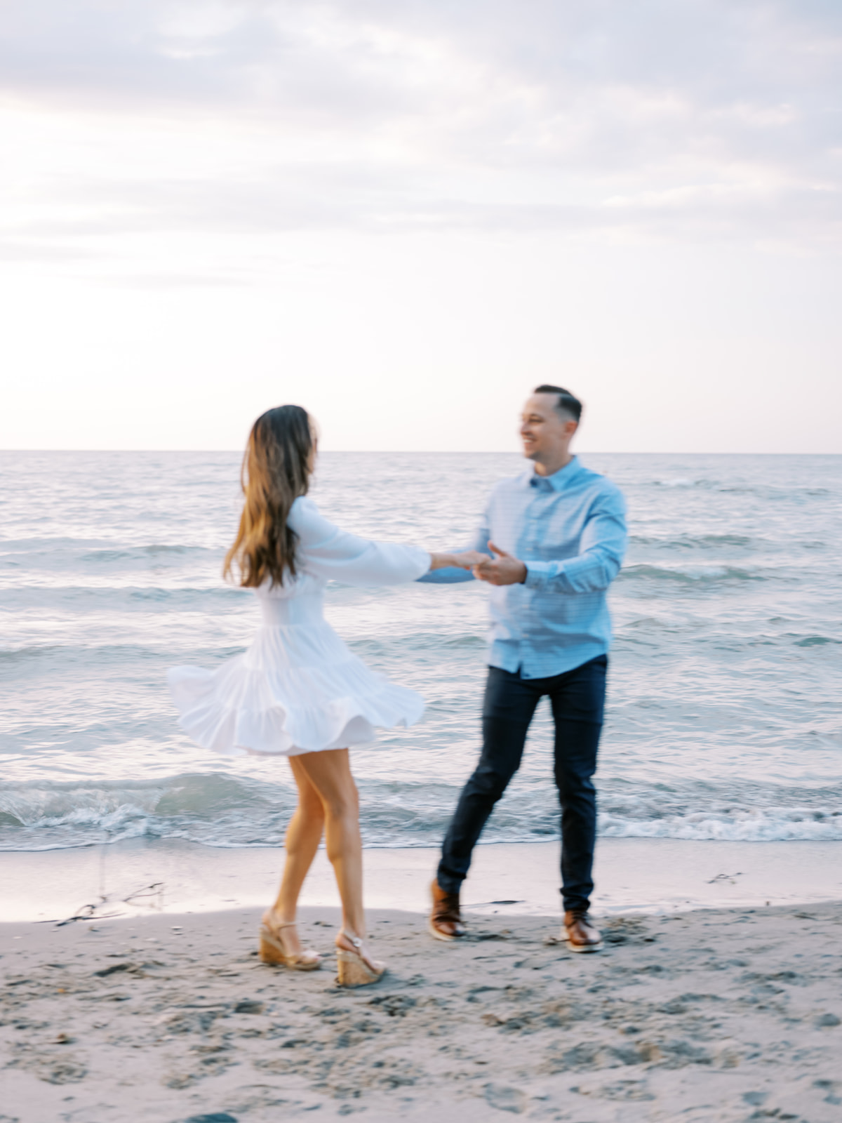 Couple twirling at their engagement session in Charleston South Carolina