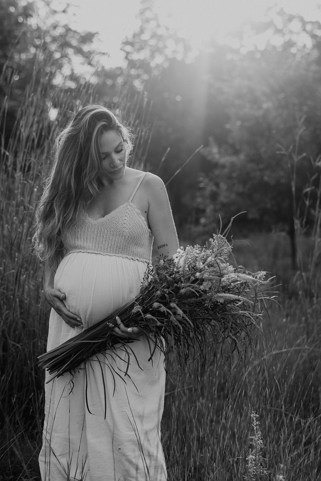 Black and white pregnancy portrait taken at sunset by a maternity photographer