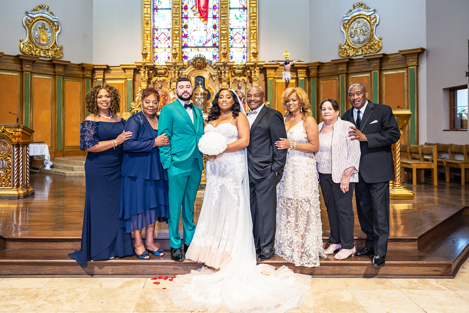 large family portrait at the alter with bride and groom