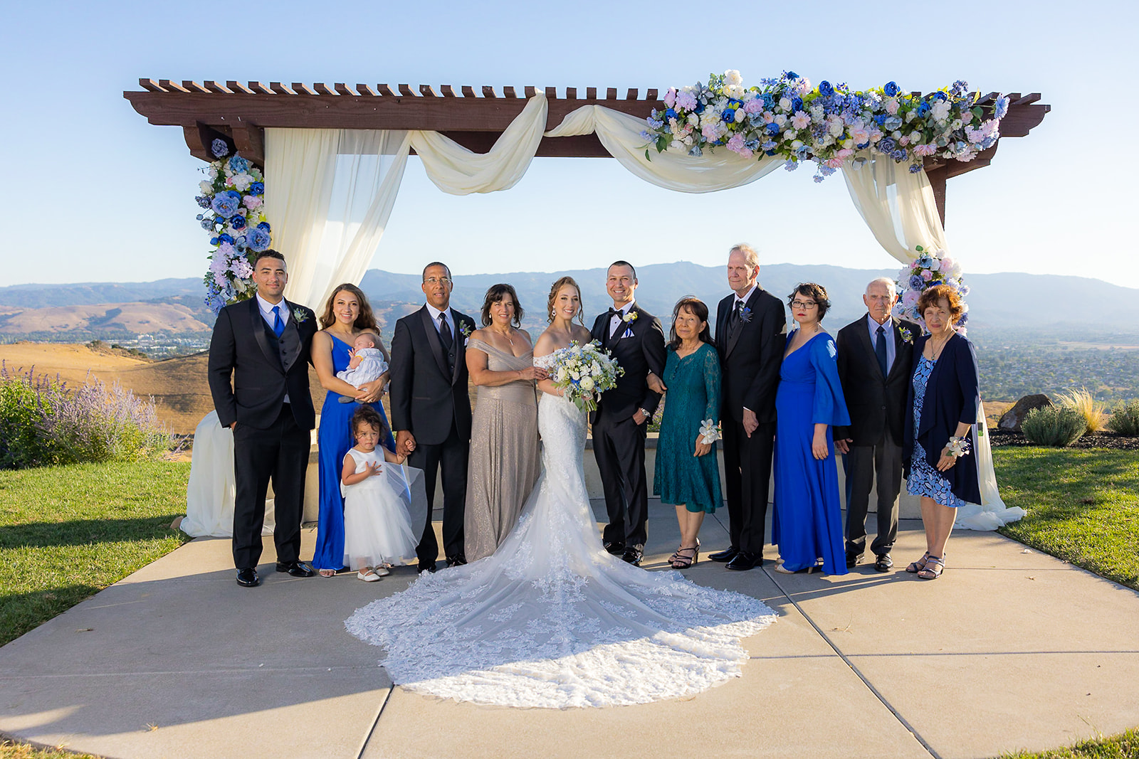 large family portrait at the alter with bride and groom
