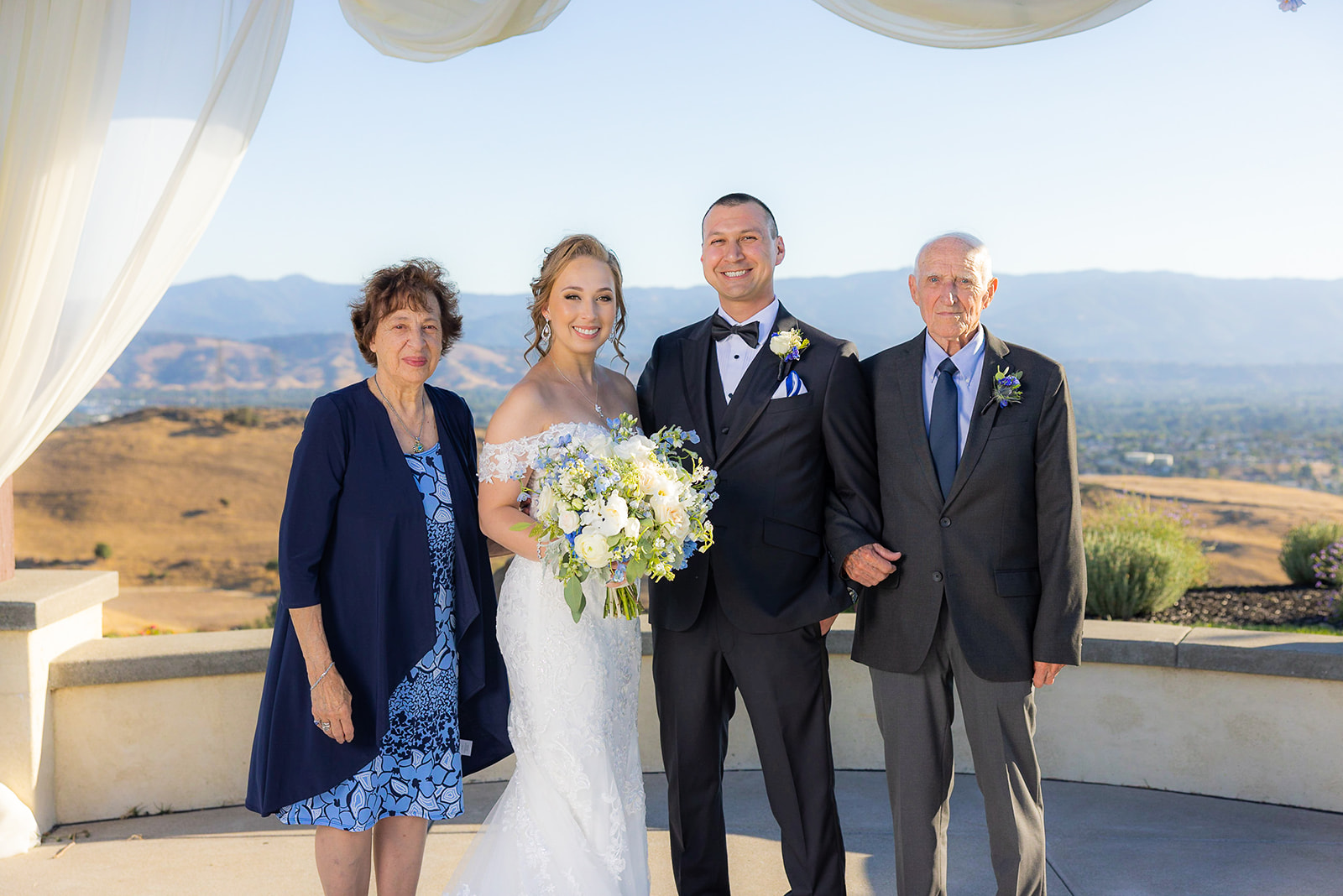 mom and dad with bride and groom for family portraits