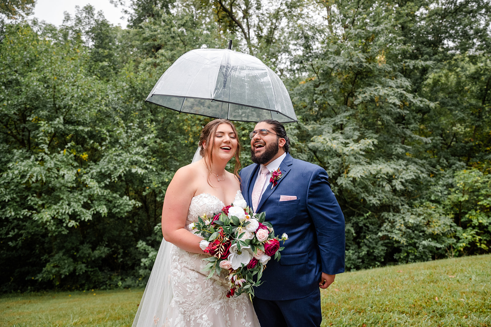 Bride and Groom holding a umbrella