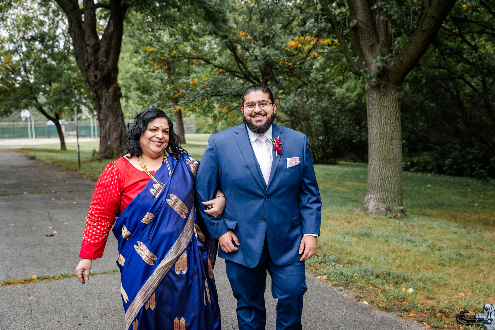 Groom with his mom who is dressed in a  sari