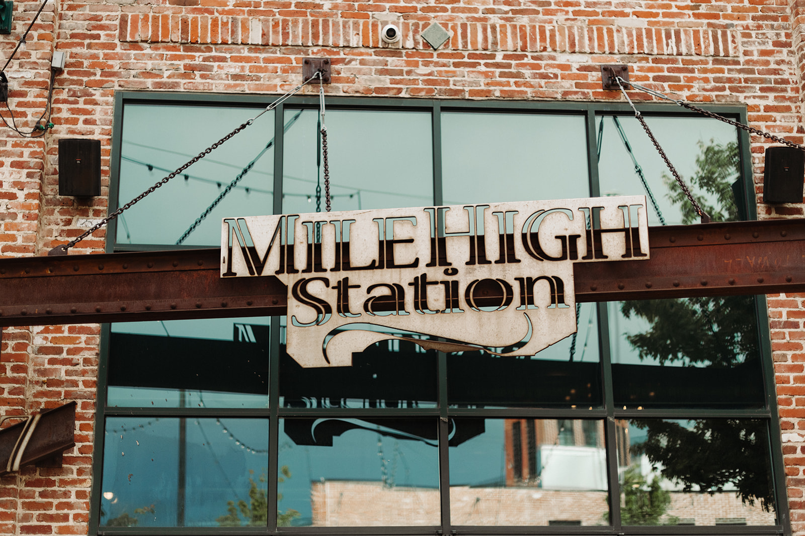 The Mile High Station sign rests above a huge window at this Denver wedding venue.