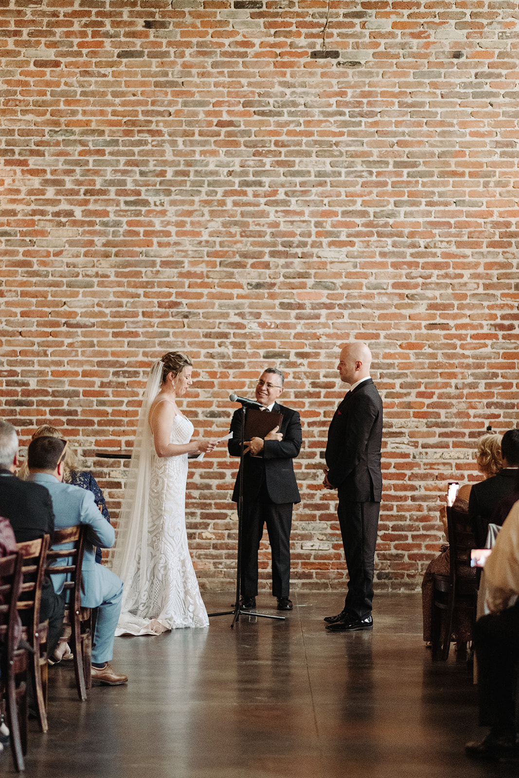 The exposed brick wall that is used as the backdrop for this Mile High Station wedding.
