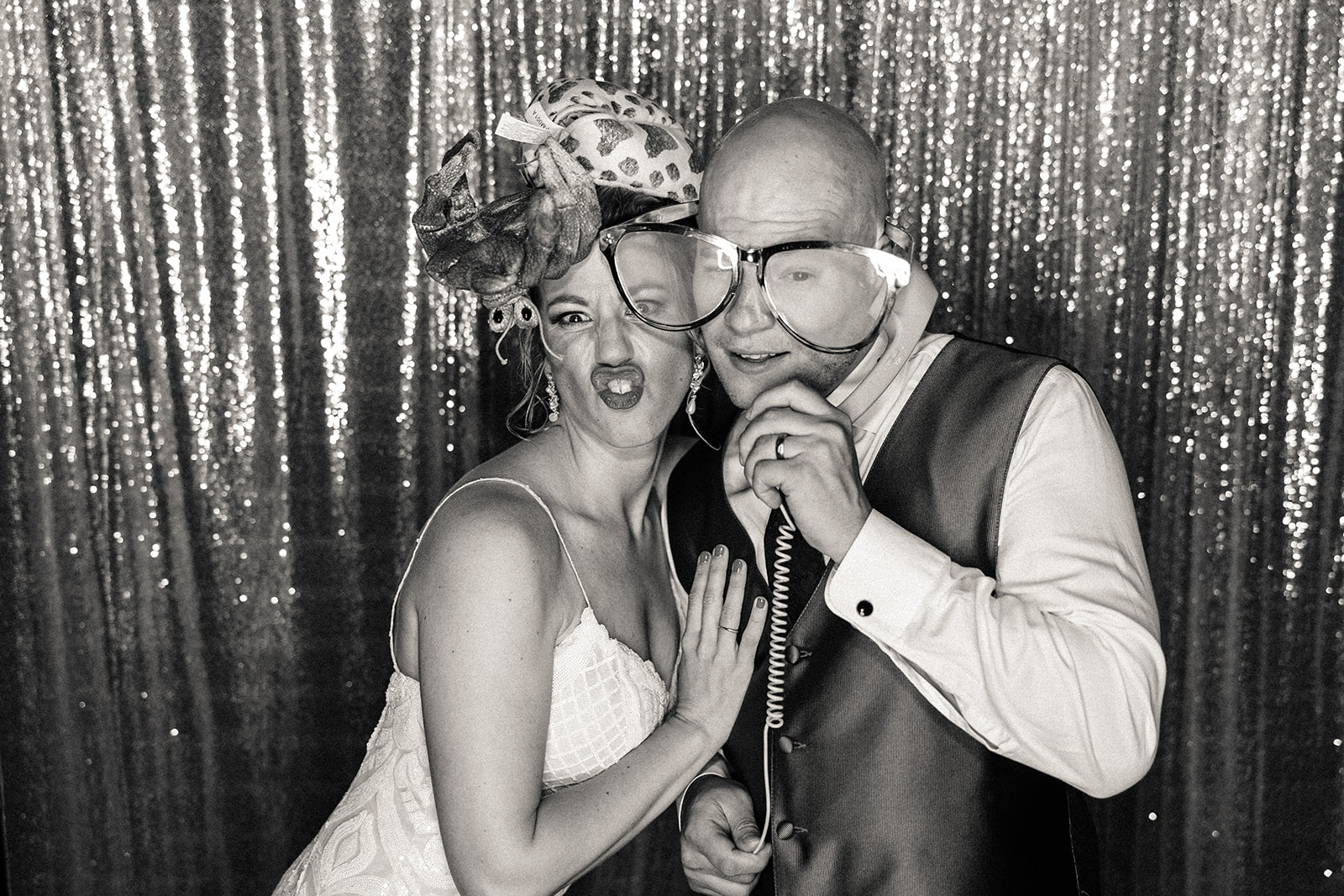 Newlyweds pose in the photo booth at their Mile High Station wedding.