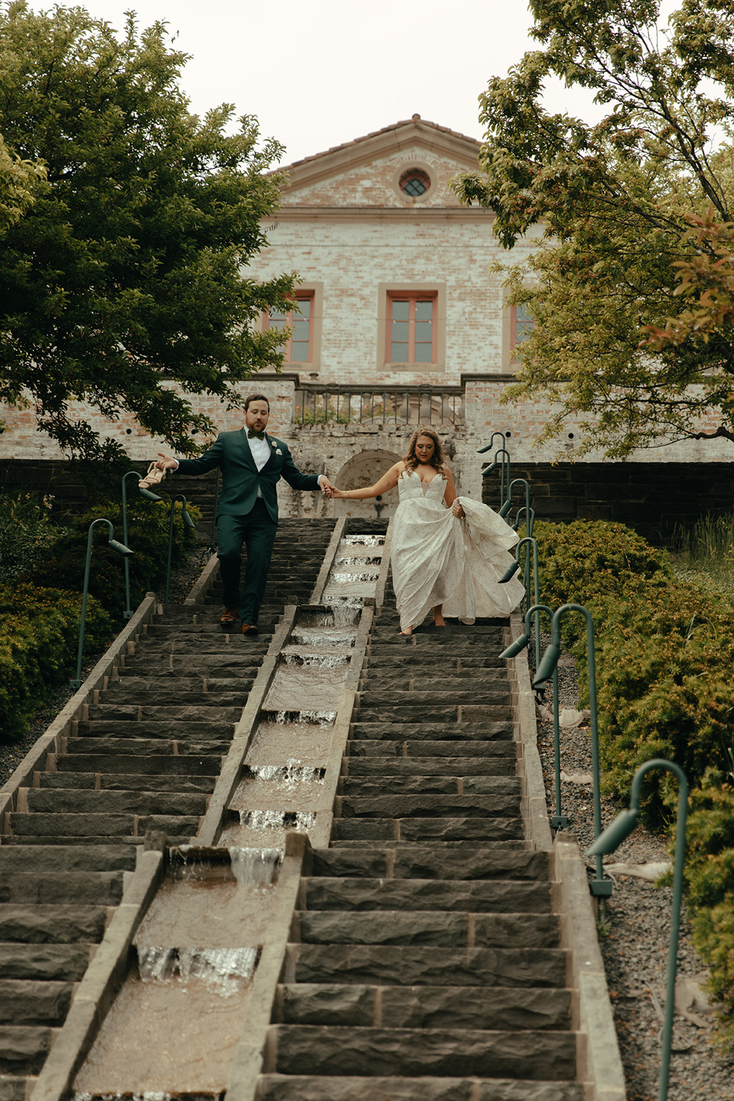 Couple walking down the steps at villa terrace