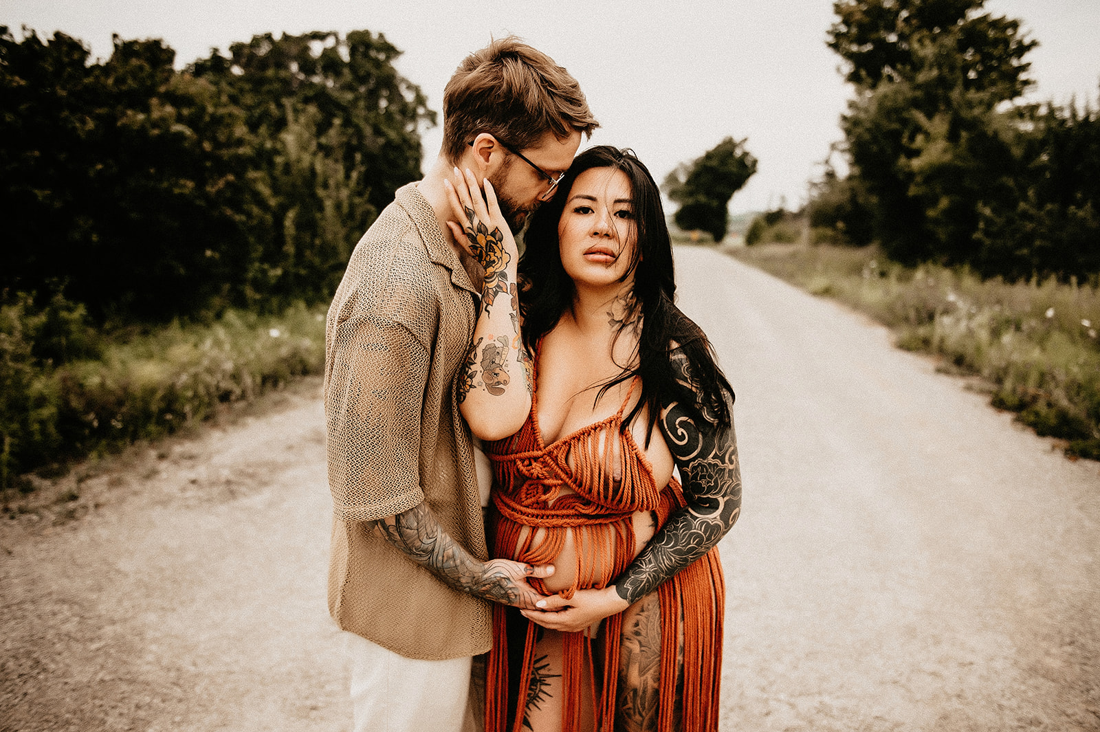 tattooed couple wearing a rope dress for maternity session