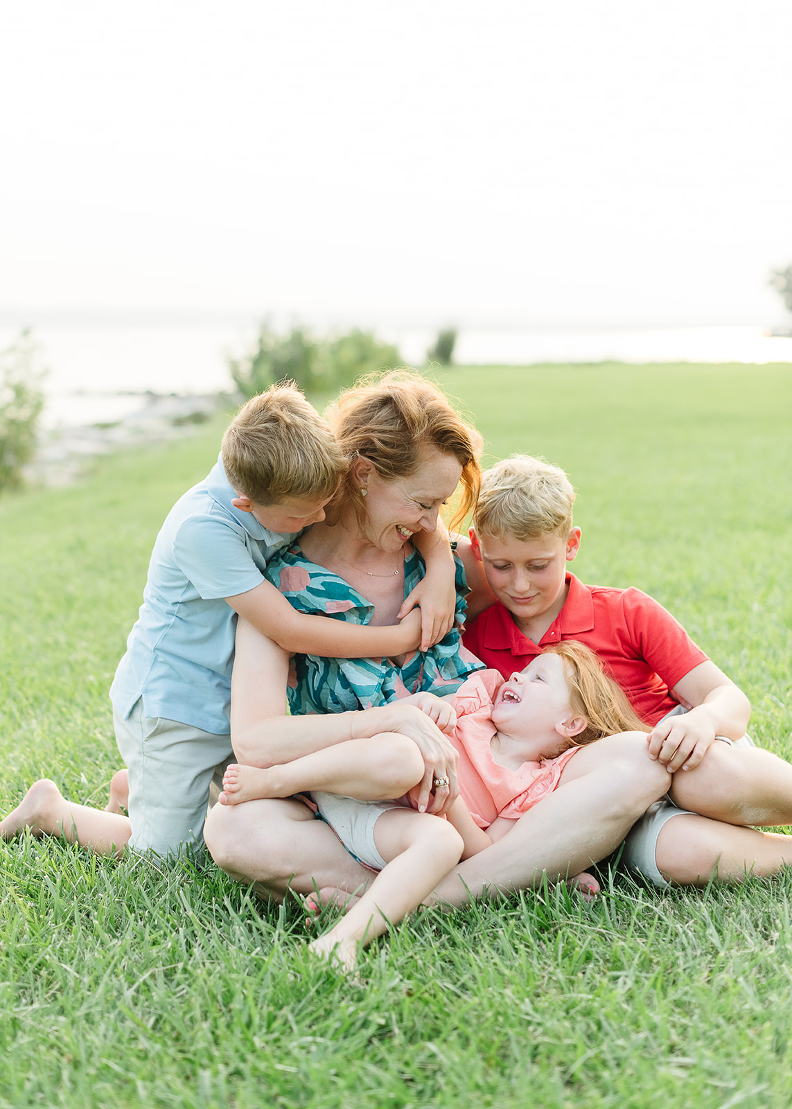 Mom and kids play in the grass at the St. Leonard Maryland beach session