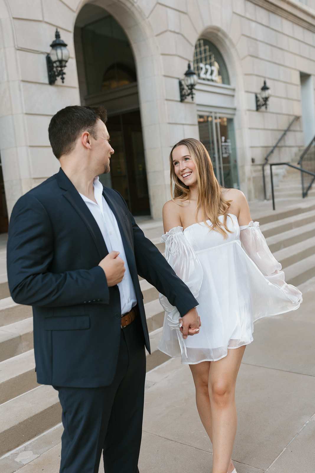 a couple getting married takes engagement photos in downtown Kansas City