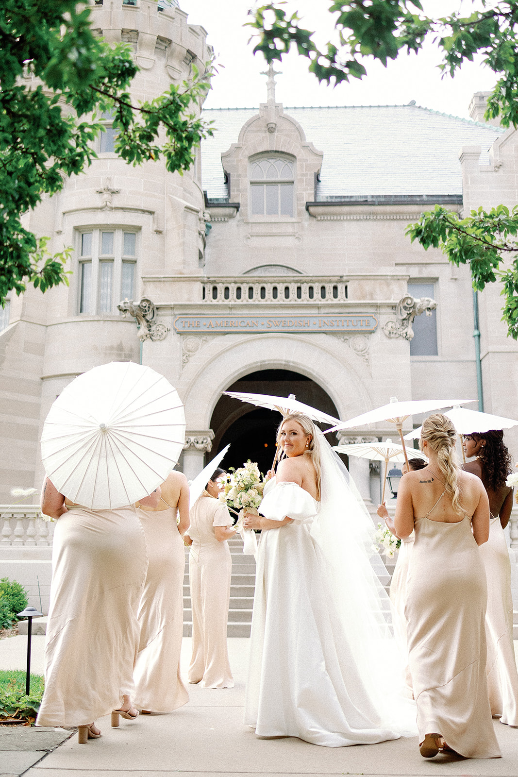 Bride with bridesmaid and parasol
