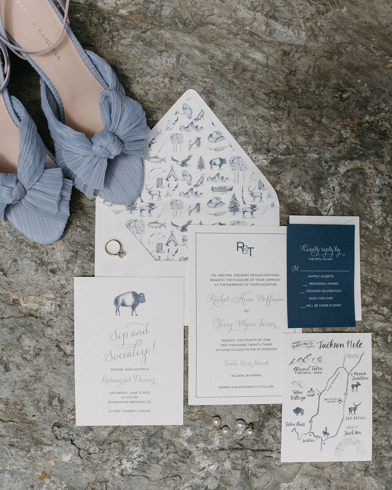 A wedding detail shot of a soft blue wedding invitation suite with soft blue Loeffler Randall Dahlia high heels. 