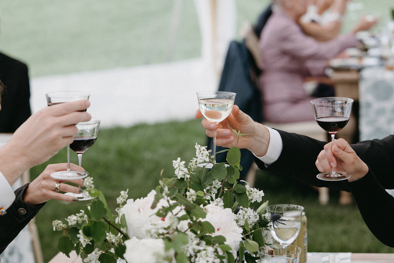 Wedding guests toast to the newly wedded couple during an outdoor wedding reception at Snake River Ranch. 