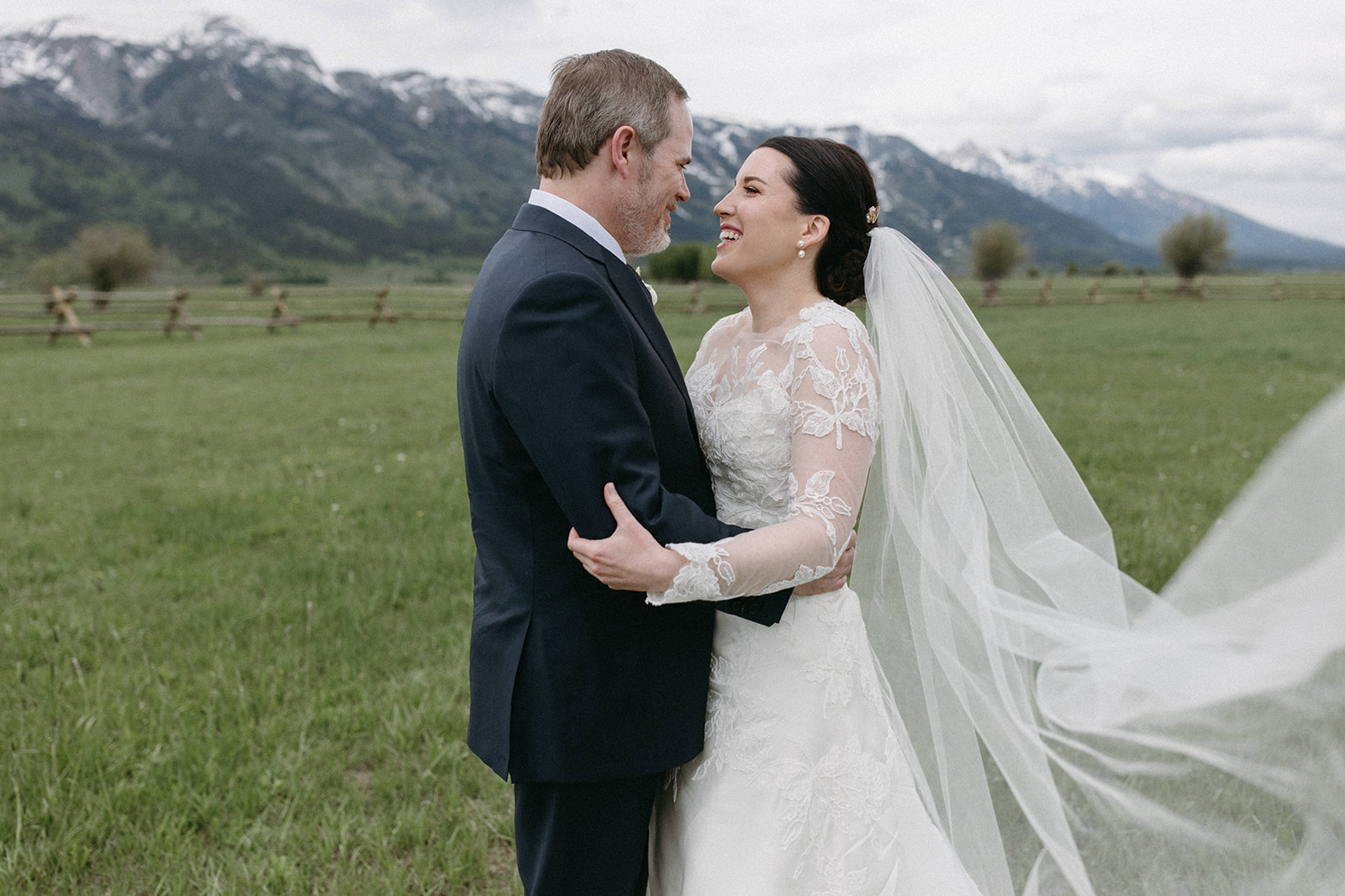 A candid shot of a bride and groom on Snake River Ranch near Grand Teton National Park in Wyoming. 