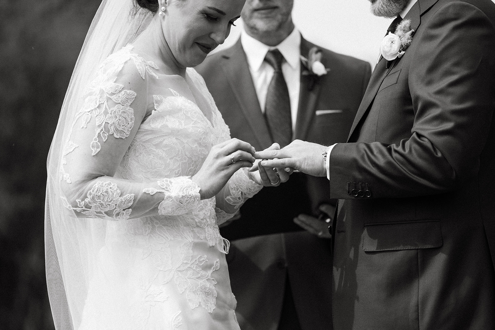 A bride and groom exchange wedding bands during their vow ceremony on a Jackson Hole ranch,
