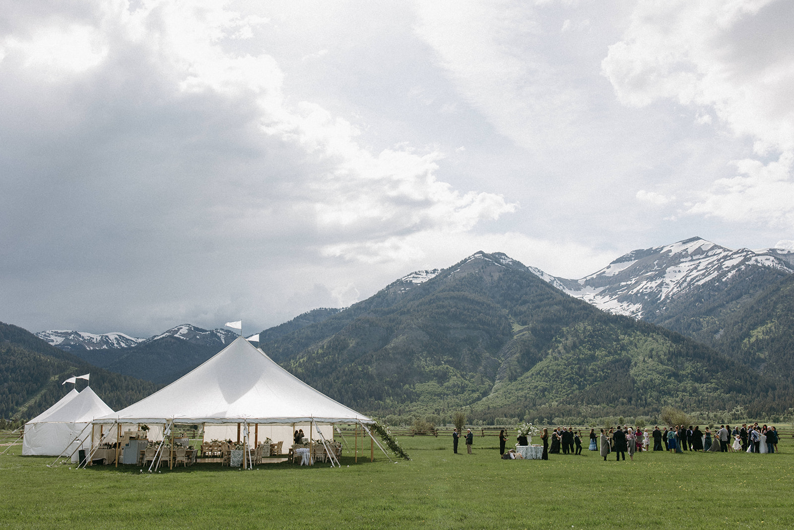 A white, outdoor wedding reception tent on a ranch in Wyoming. 