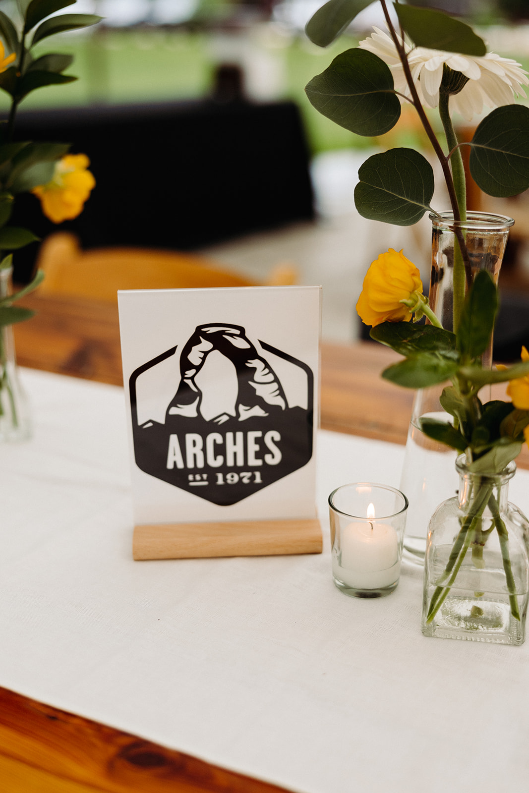 A close-up photo of a reception table sign, designed after memorable places in their relationship.