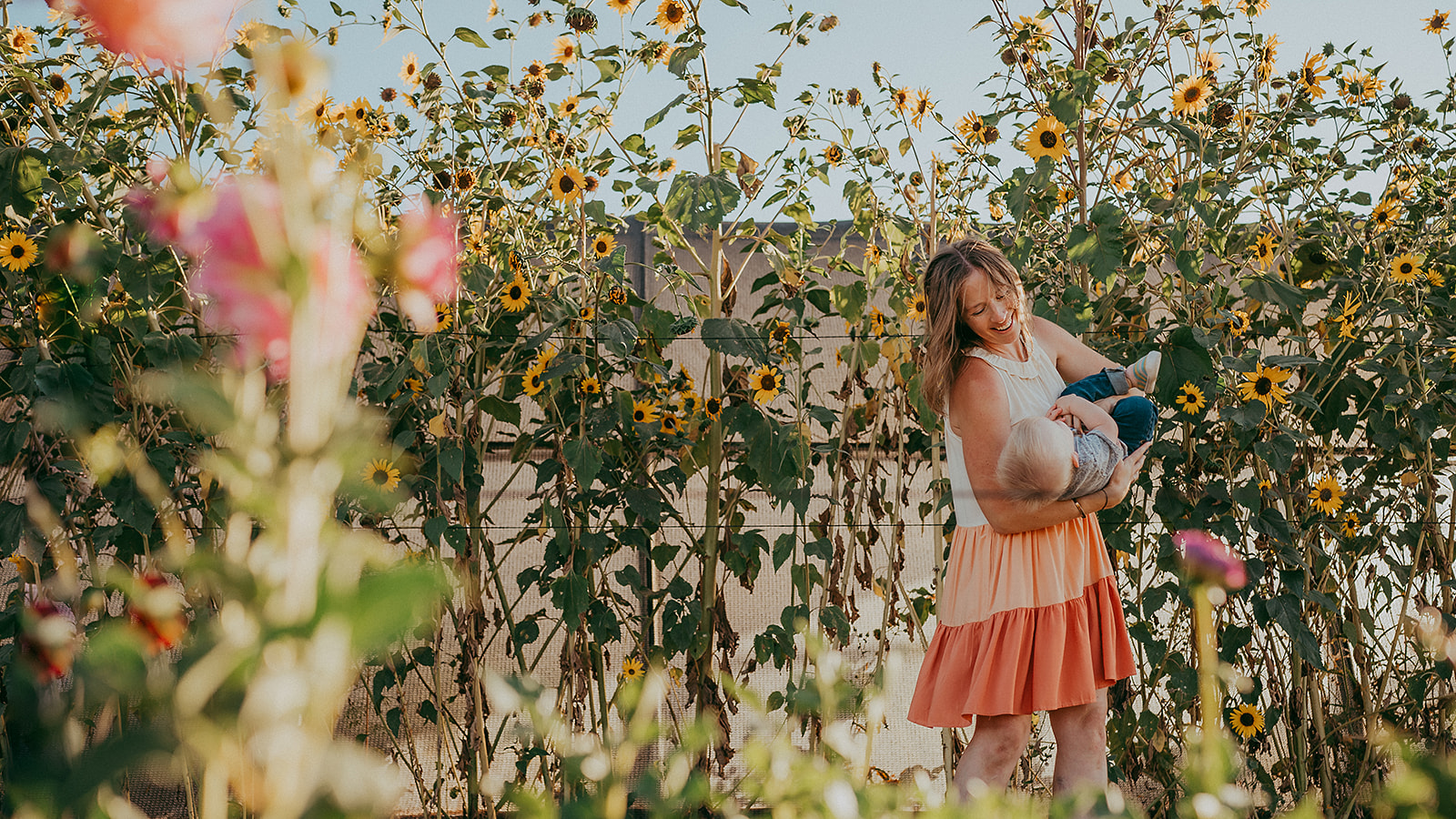 Photo of mother swinging baby in a beautiful flower farm in Petaluma, California, by Sunshine Lady Photography