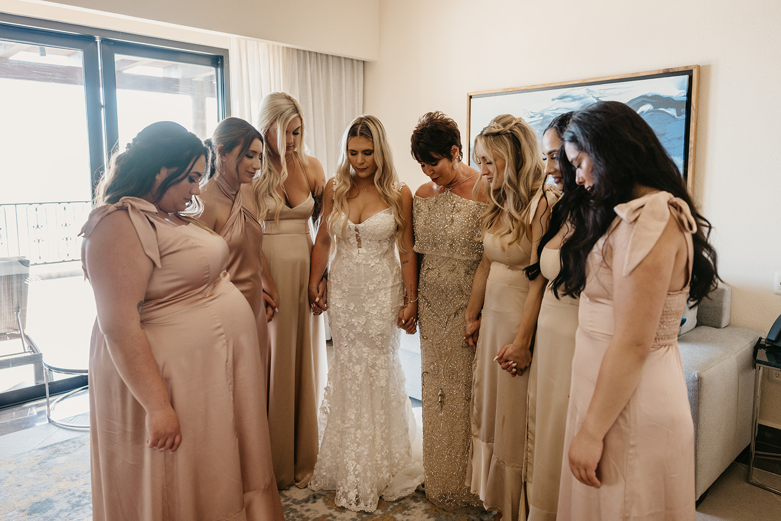 Bride has a prayer with her bridesmaids