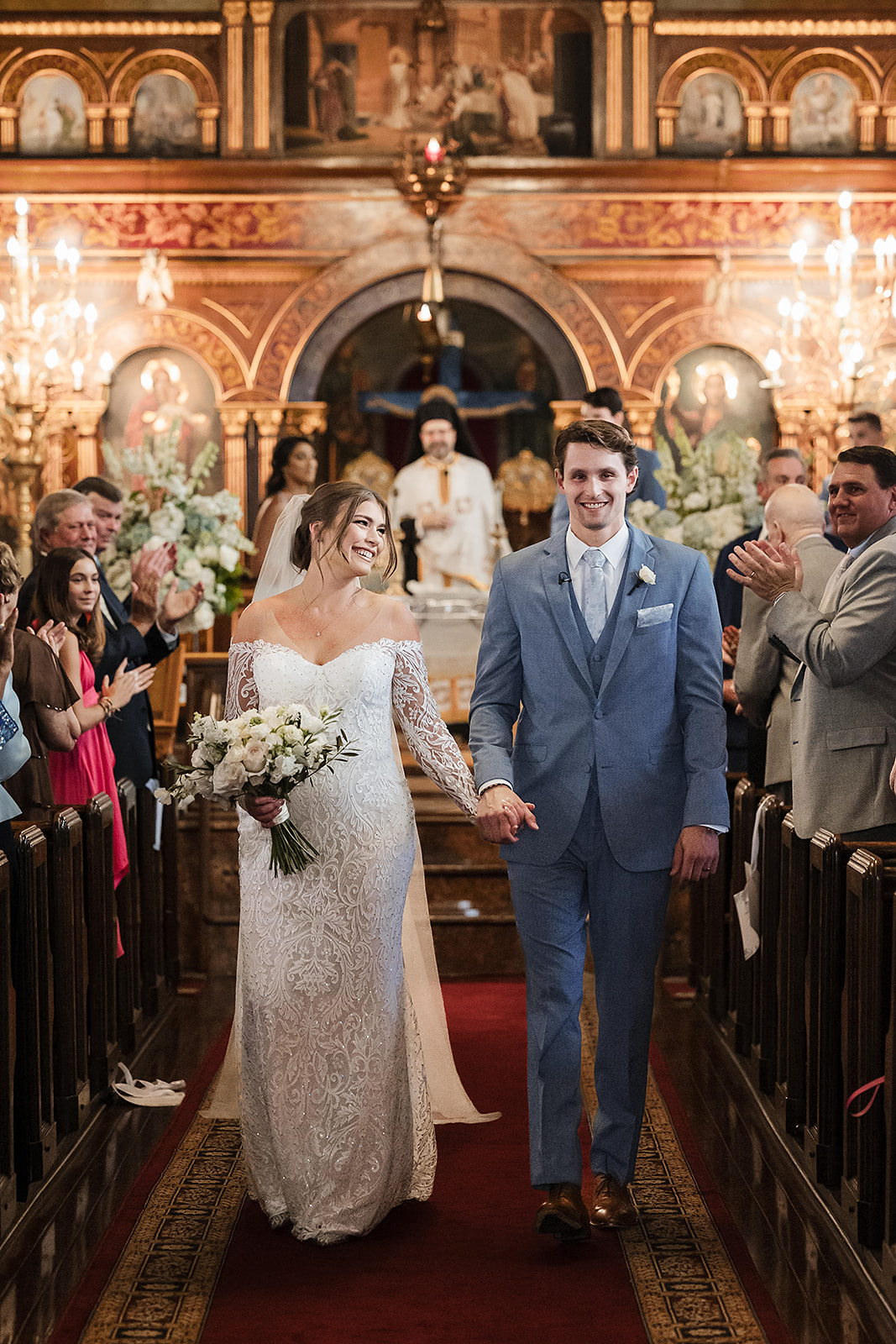Bride and groom walking down the aisle at St. George Greek Orthodox Cathedral in Philadelphia wedding 