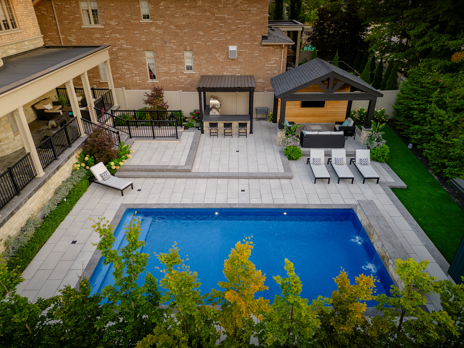 Drone shot of the inground pool and outdoor furniture.