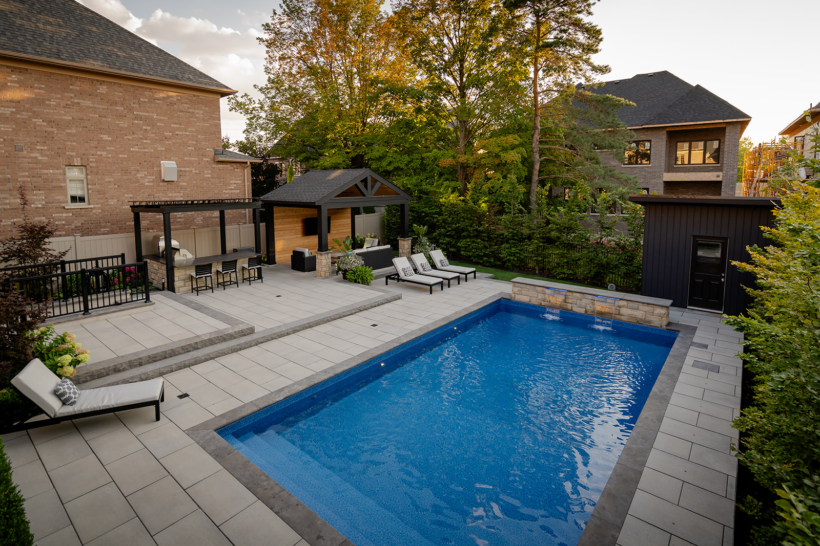An inground pool with patio stones surrounding it.