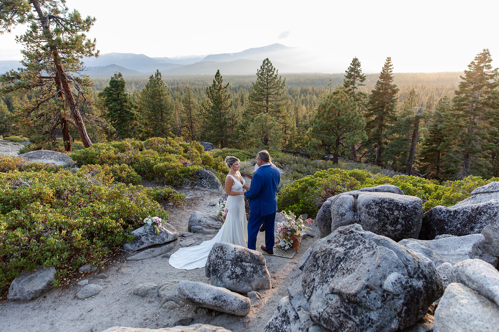 Couple exchanging their vows overlooking Lake Tahoe during their elopement in the Sierra Mountains. 