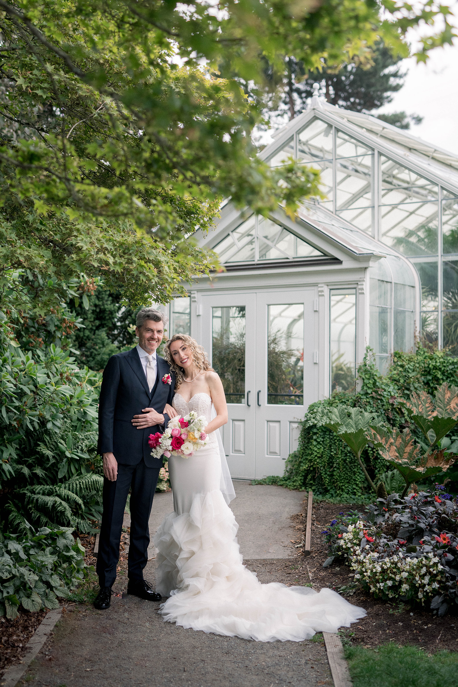 bride and groom hold each other at volunteer park