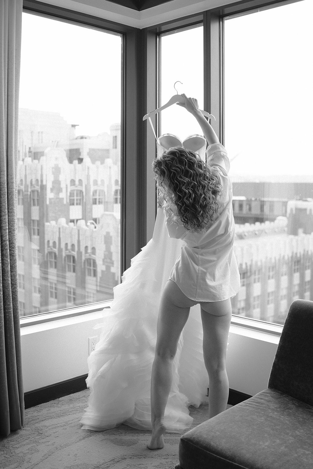 bride holds up wedding dress