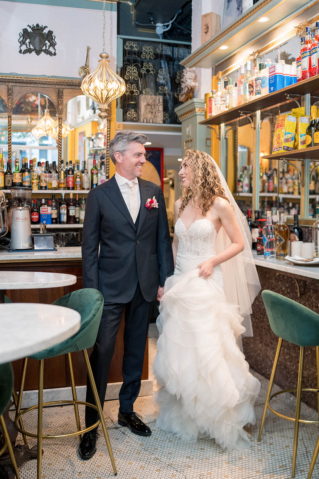 bride and groom sit in bar together and look at each other