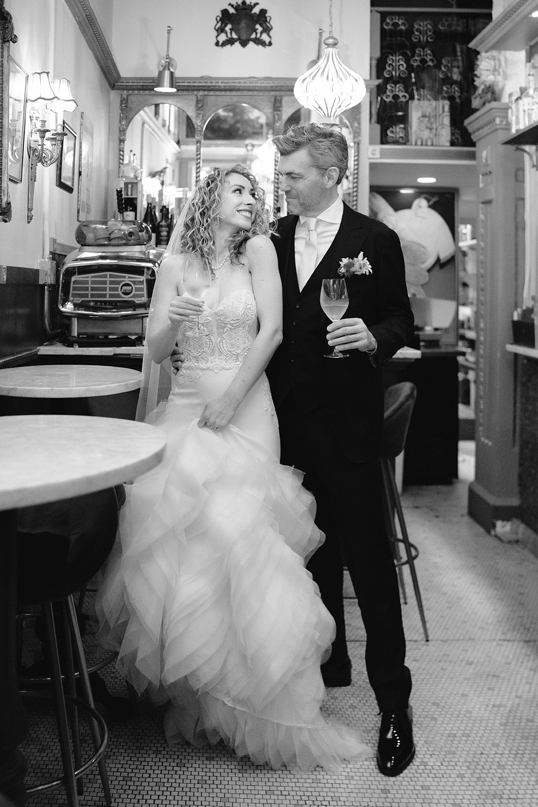bride and groom sit together in bar