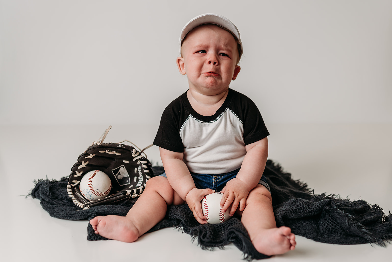 Baby makes sad face during photos with Heather Ann Photography