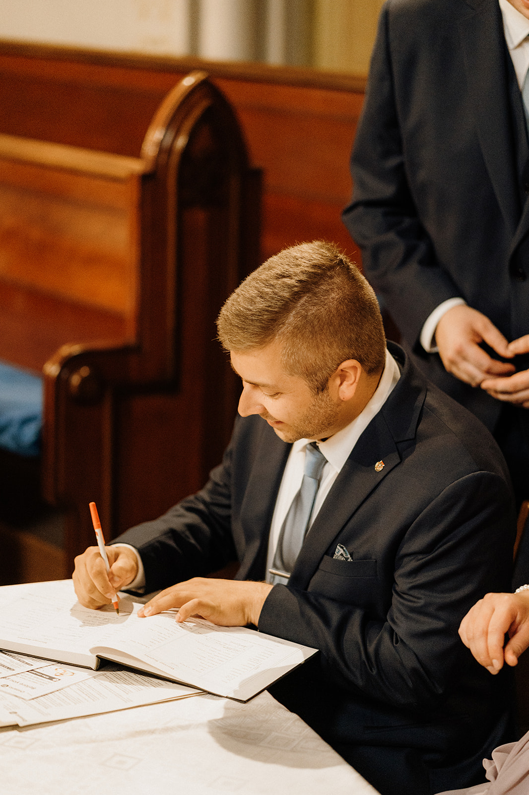 A man signing papers.