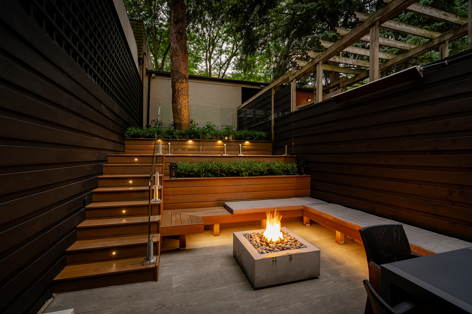 A seating area with a lit fireplace in the middle.