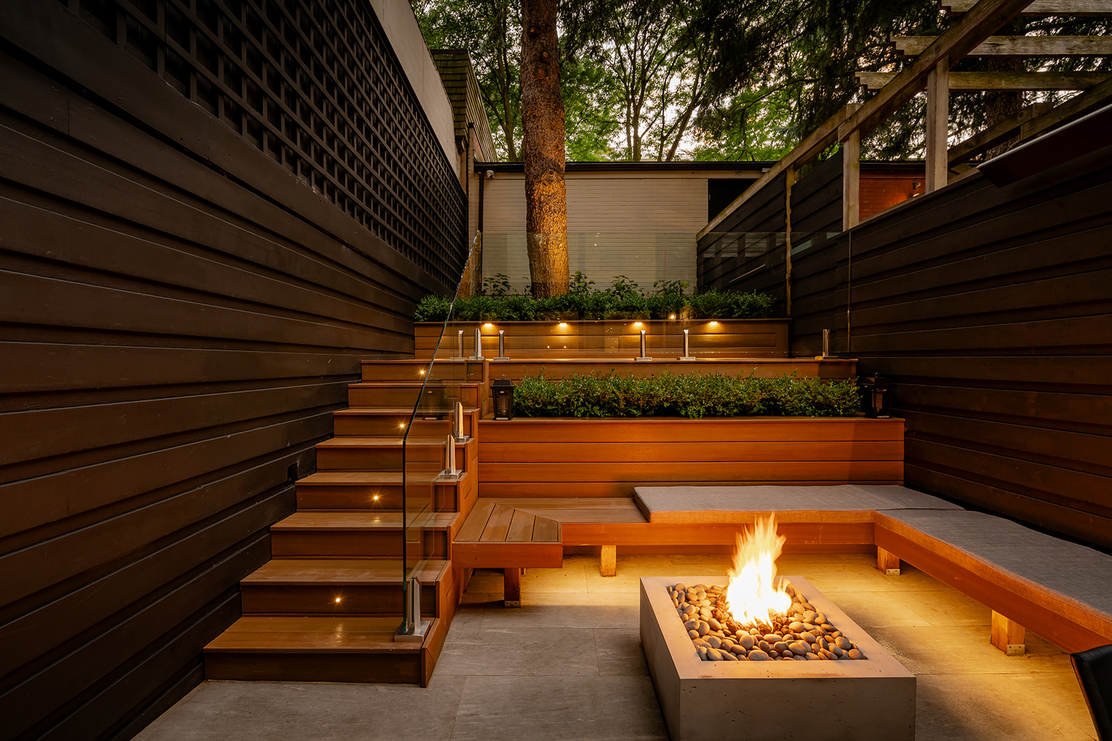 A seating area with a lit fireplace in the middle.