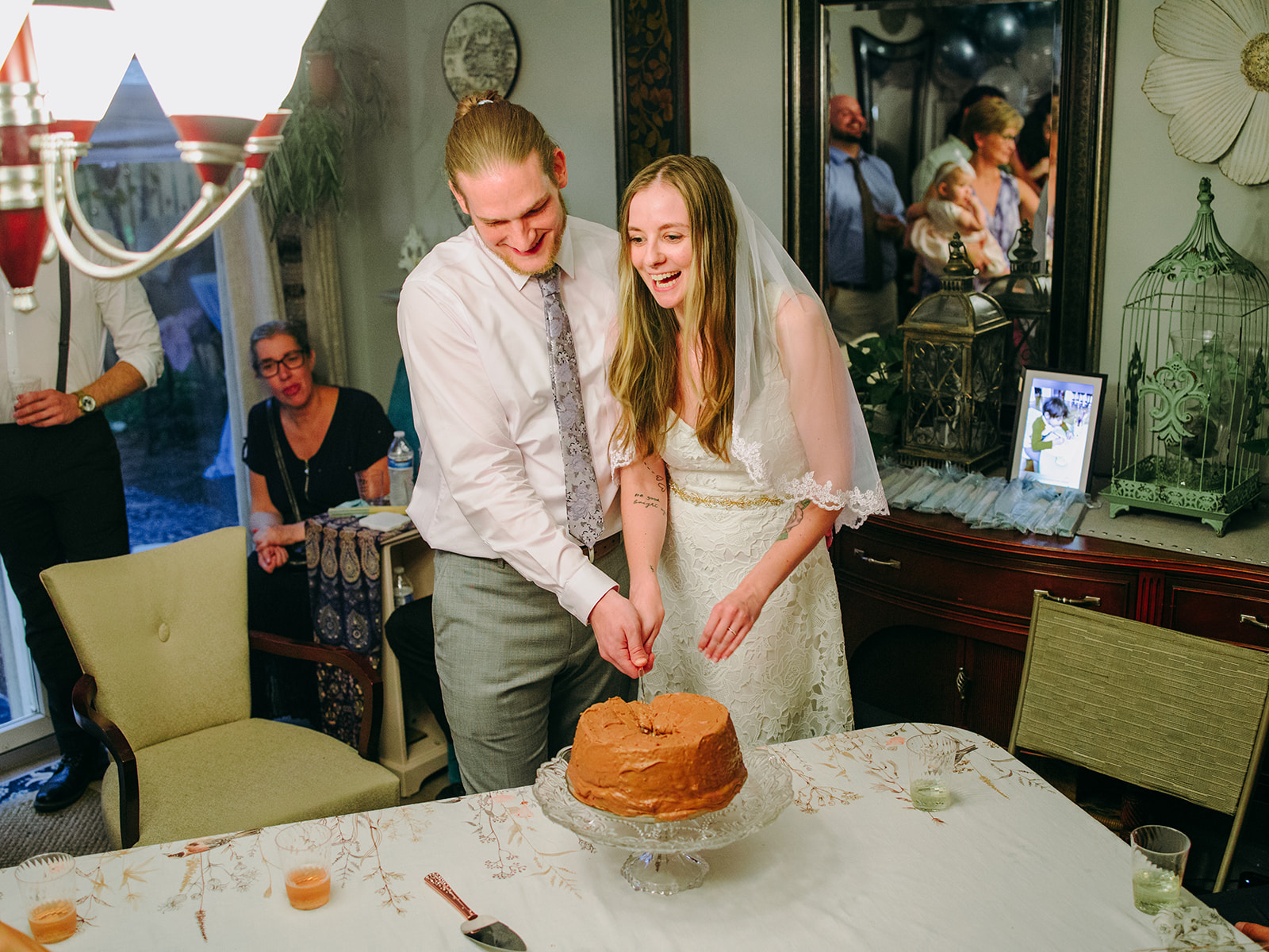 bride and groom cut their cake at their in home wedding