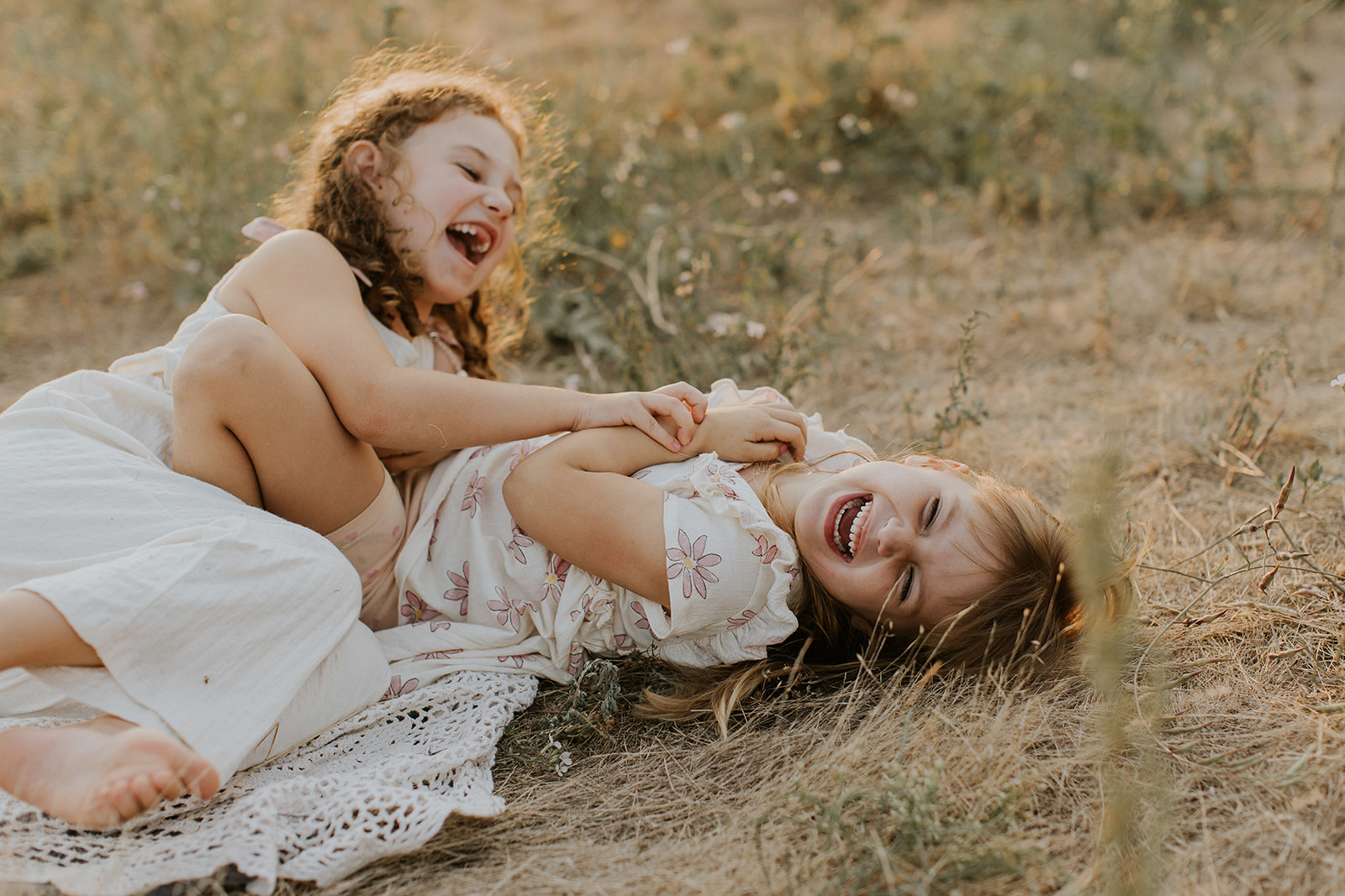 two sisters tickling each other