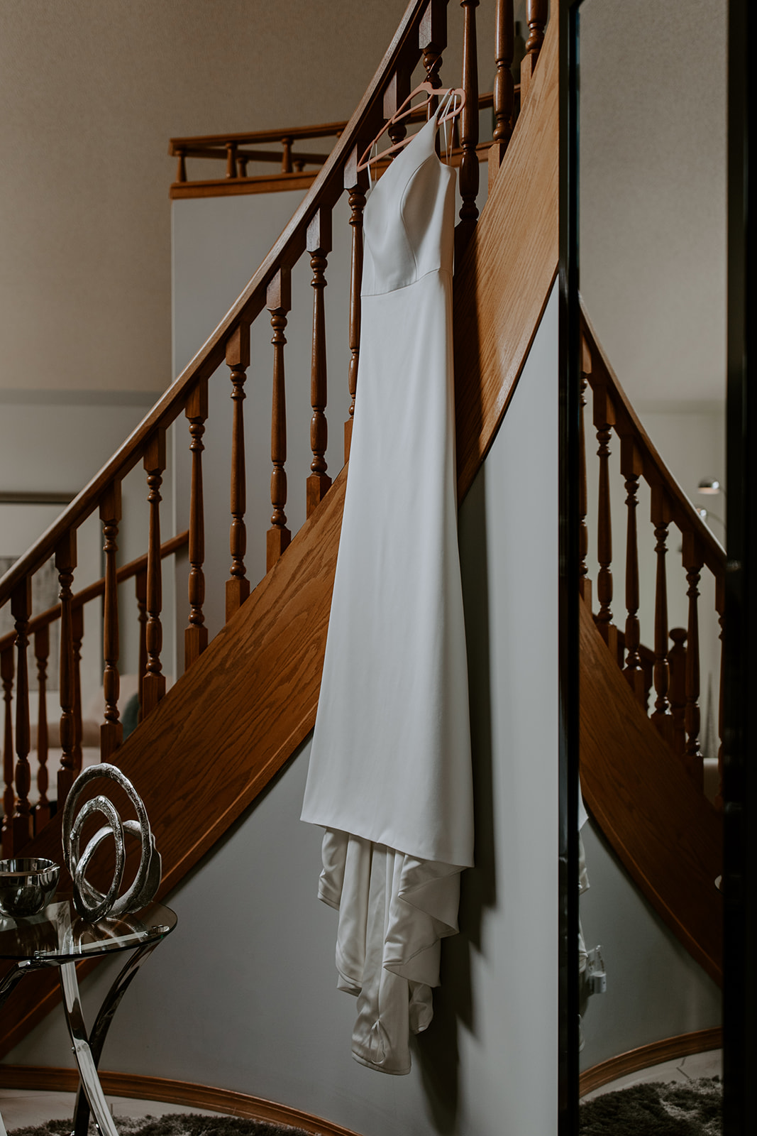 Wedding dress hanging on stairs 