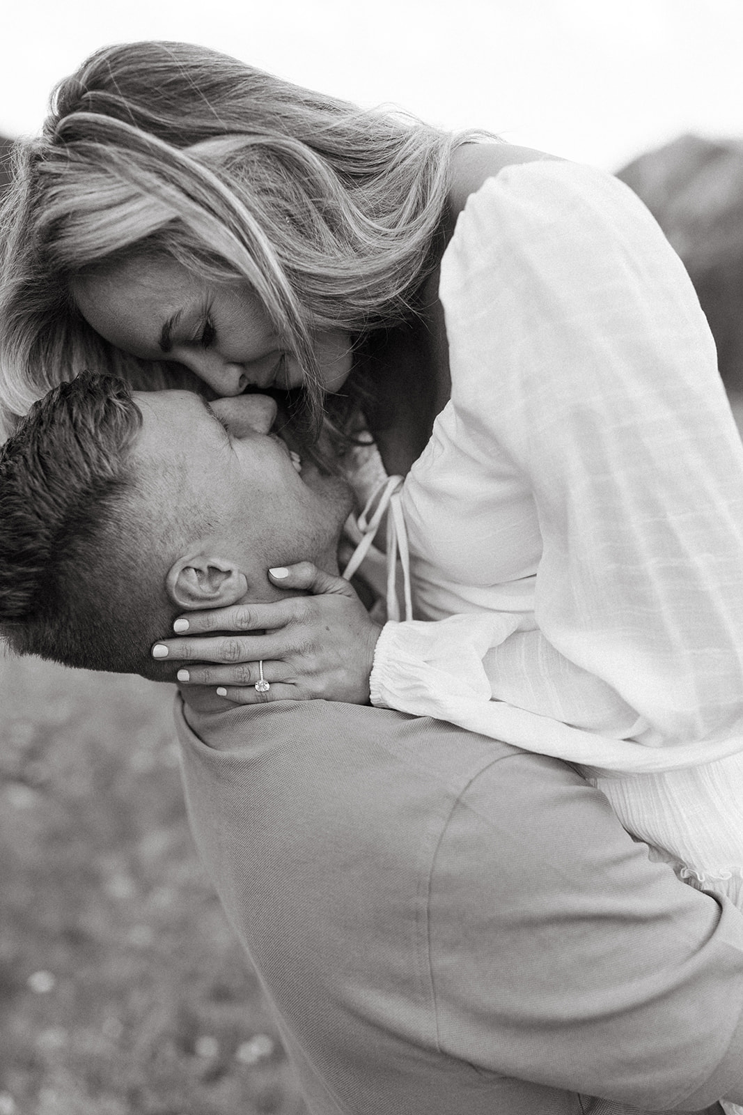 An engaged couple shares a kiss during their luxury engagement session photographed by an Aspen Wedding Photographer. 