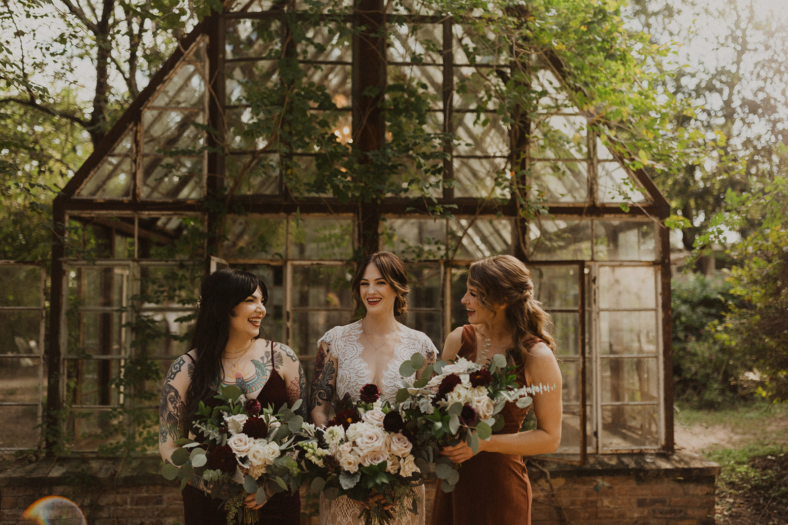 bride poses with bridesmaids holding wedding bouquets
