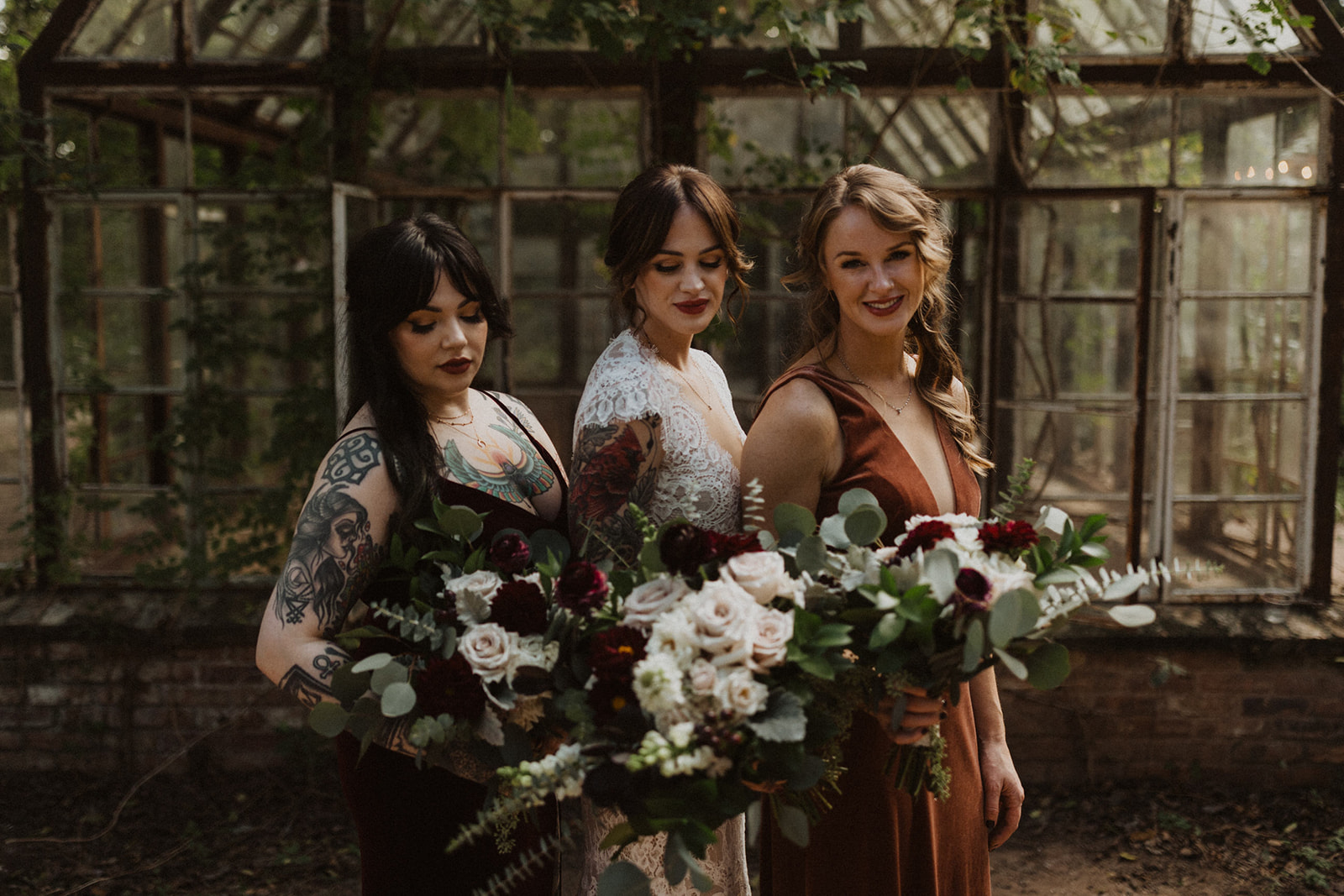 bride poses with bridesmaids holding wedding bouquets