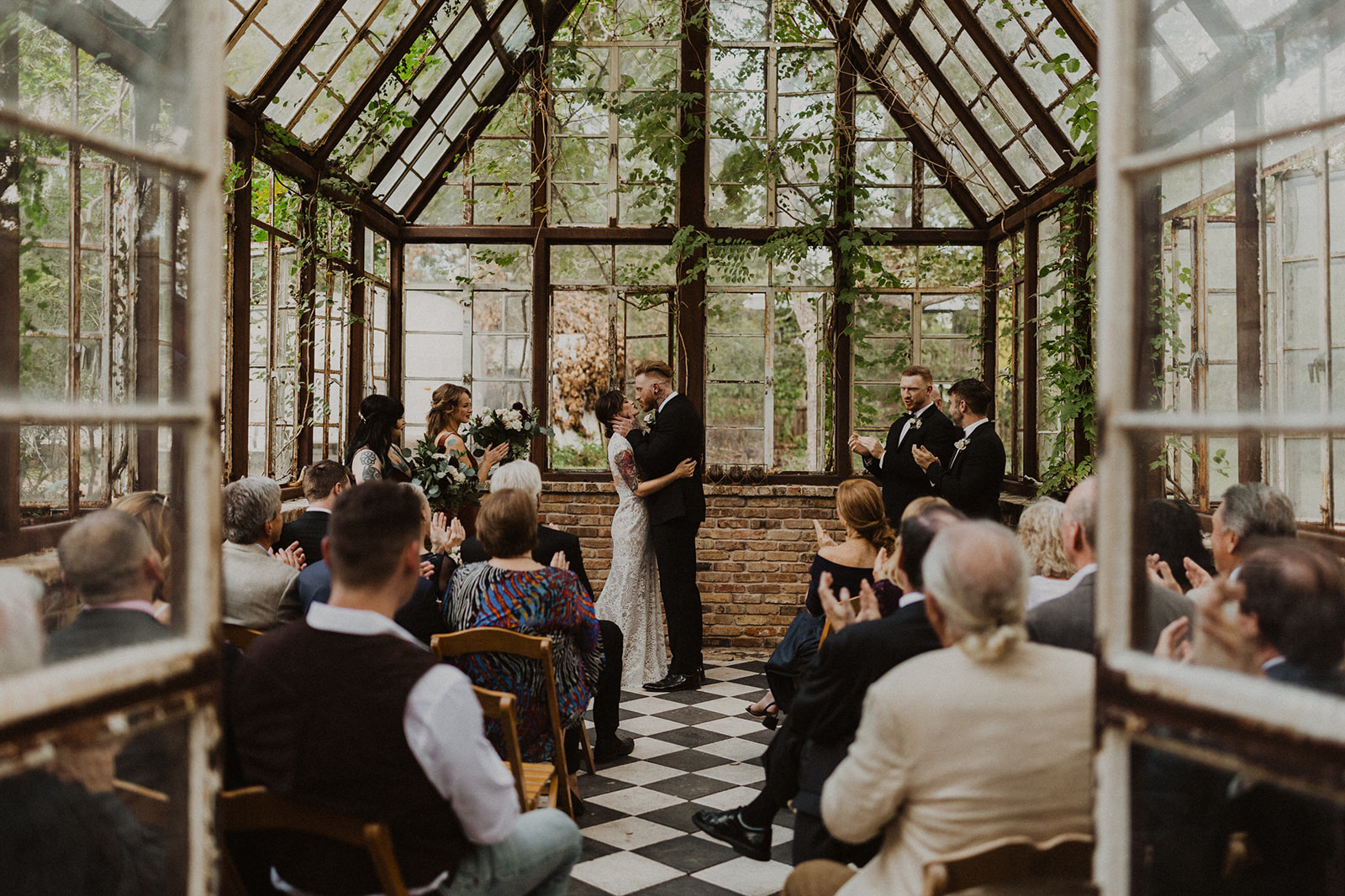 couple exchanges vows at Sekrit Theater greenhouse wedding