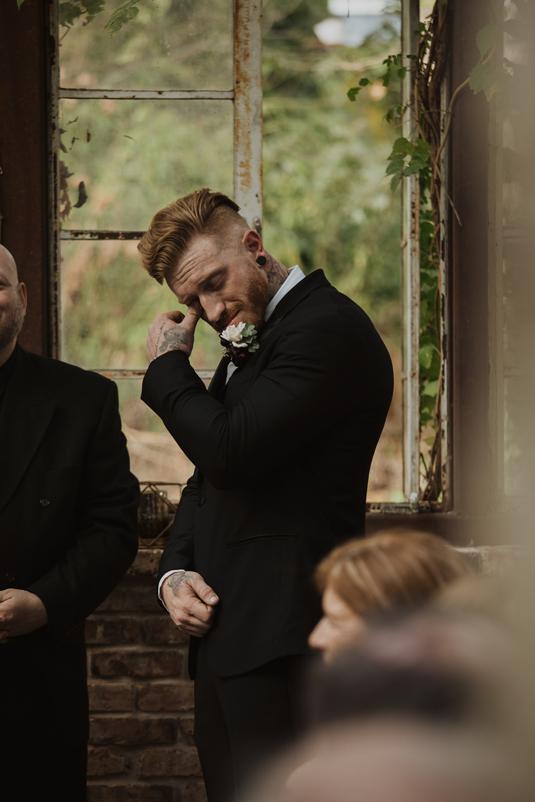 groom cries during ceremony at Sekrit Theater greenhouse wedding