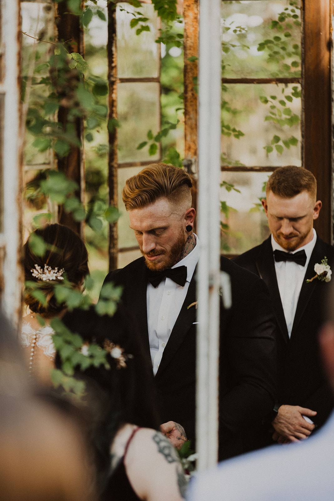 groom exchanges vows at Sekrit Theater greenhouse wedding