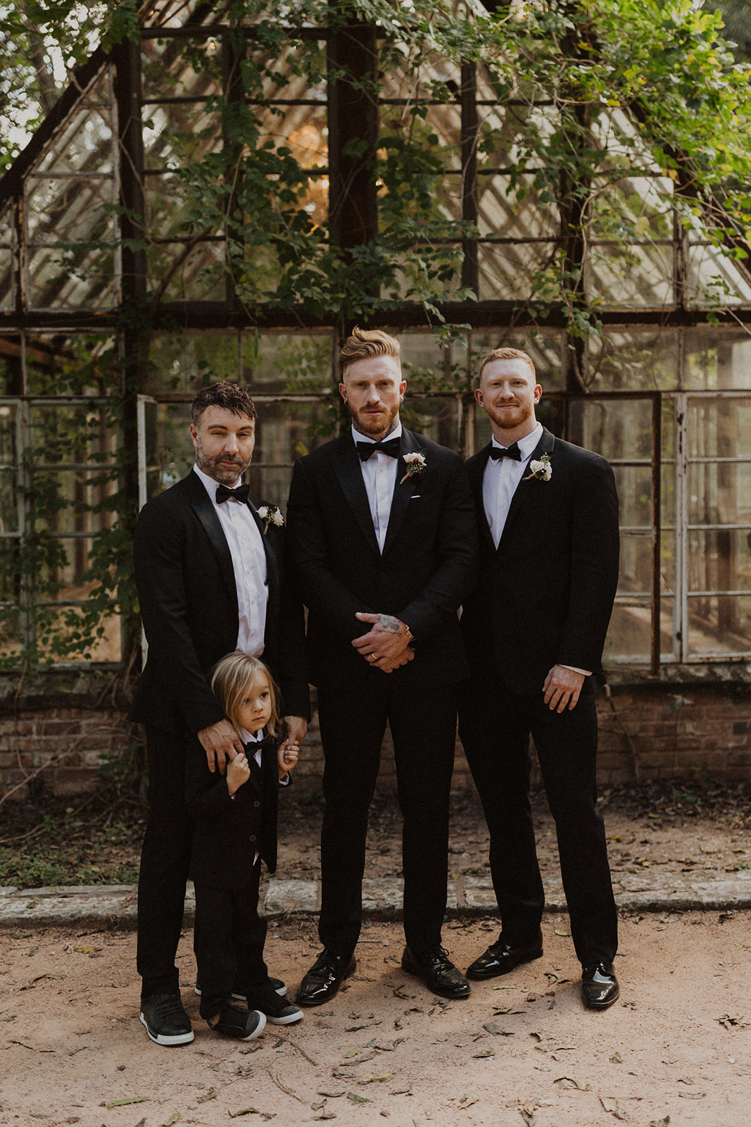 groom stands with groomsmen at Sekrit Theater greenhouse wedding
