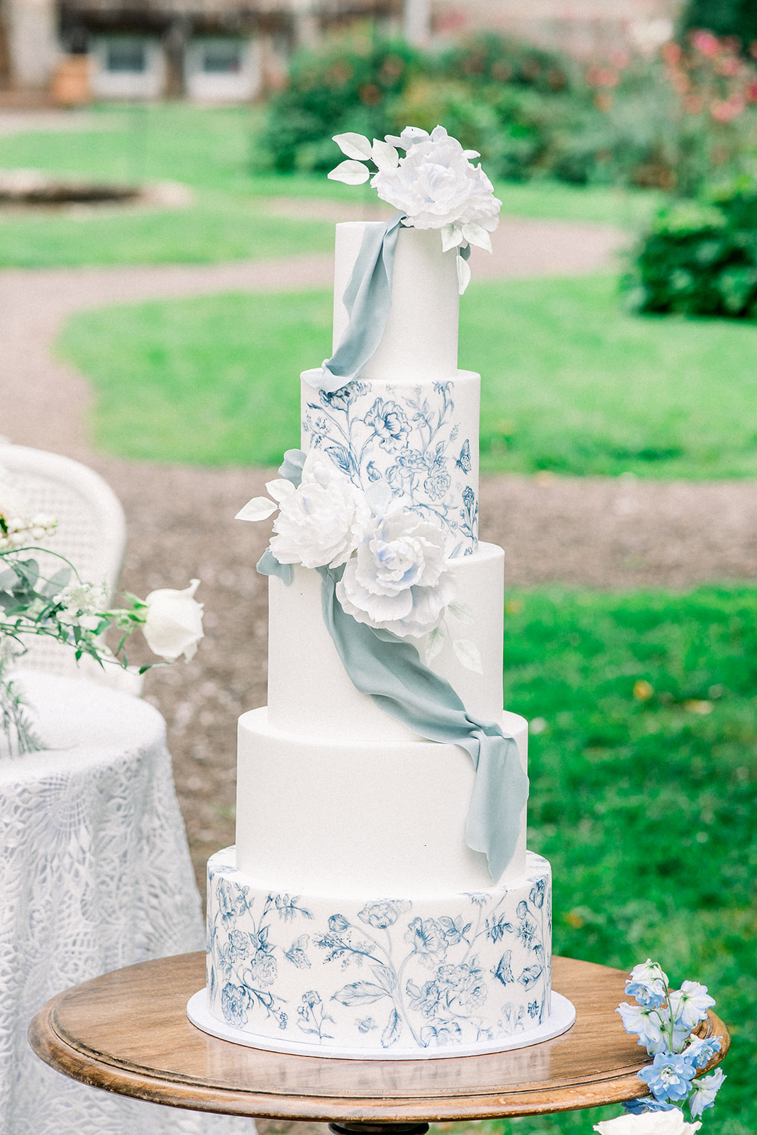 Artisan wedding cake by Erzulie featuring lace details, at an Ireland destination wedding within the storied walls of Ca